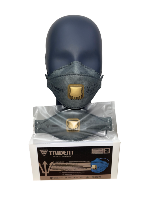 Trident carbon valved FFP3 respirator in dark grey, shown on a black mannequin head with a gold exhalation valve. The mask is displayed above its box of 20 units, featuring advanced filtration against airborne particles and odours, certified to EN 149:2001+A1:2009 FFP3 NR.