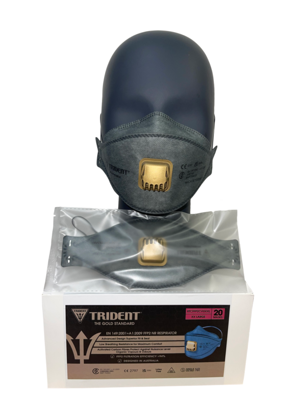 Trident carbon valved FFP3 respirator in dark grey, shown on a black mannequin head with a gold exhalation valve. The mask is displayed above its box of 20 units, featuring advanced filtration against airborne particles and odours, certified to EN 149:2001+A1:2009 FFP3 NR."