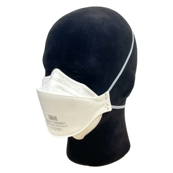 3M Aura 9320D+ disposable FFP2 NR D mask shown displayed on a mannequin head. The mask features a three-panel design for improved facial fit and comfort, with headband straps and embossed top panel to reduce fogging. Certified to EN 149:2001 standards.