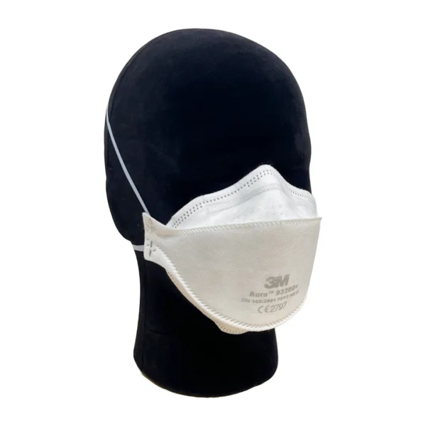 3M Aura 9320D+ disposable FFP2 NR D mask shown displayed on a mannequin head. The mask features a three-panel design for improved facial fit and comfort, with headband straps and embossed top panel to reduce fogging. Certified to EN 149:2001 standards.