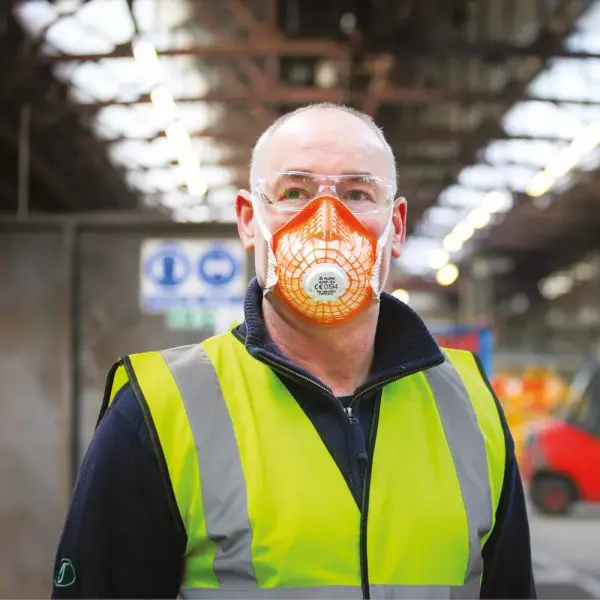 Man in warehouse wearing Alpha Solway Alpha Flow AMF-3V mask